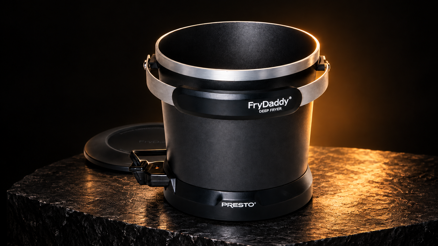 Close view of FryDaddy's black body, silver rim, and included scoop